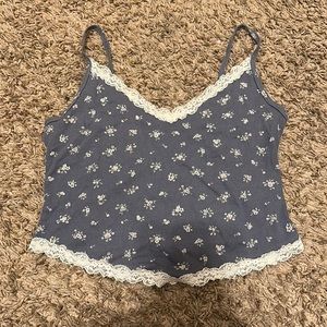 Blue holster top with white lace around the edges with flowered print.
